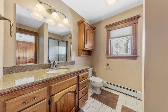 bathroom featuring tile patterned flooring, vanity, toilet, and a baseboard radiator