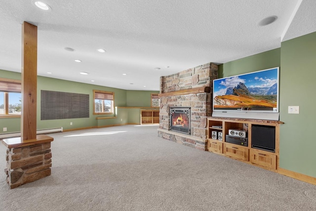 living room featuring a fireplace, a textured ceiling, and carpet floors