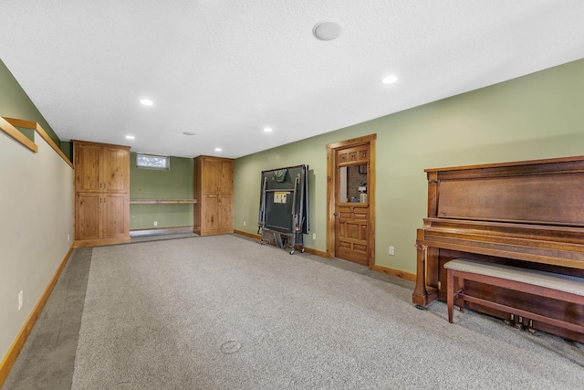 unfurnished living room featuring light carpet and a textured ceiling