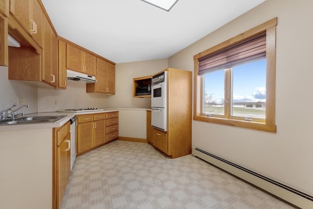 kitchen with baseboard heating, sink, and white appliances