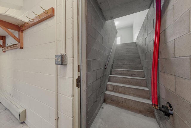 stairs featuring concrete floors