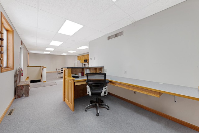 home office featuring a paneled ceiling and light colored carpet