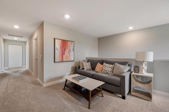 living room featuring a textured ceiling and light colored carpet