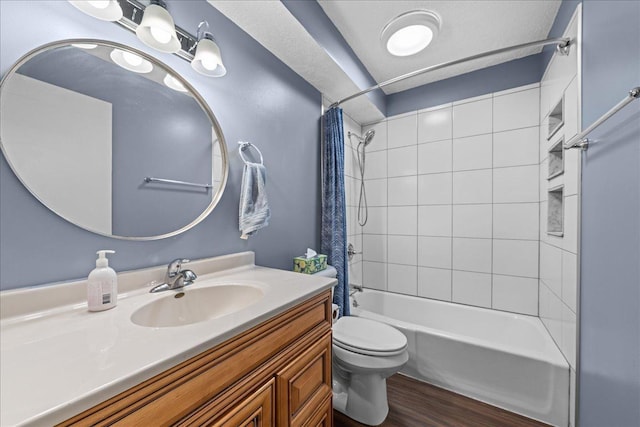 full bath with wood finished floors, vanity, toilet, and shower / bath combo