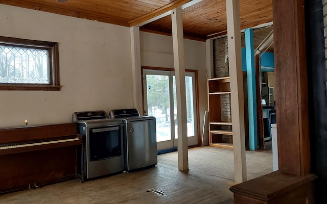 laundry room with wood ceiling, washer and dryer, laundry area, and wood finished floors