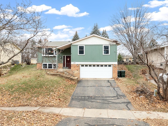 view of front of home with a front lawn and a garage