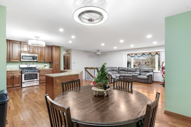 dining space with light hardwood / wood-style floors