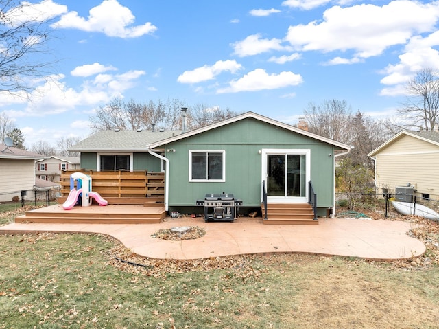 rear view of property with a patio area, a lawn, and a deck