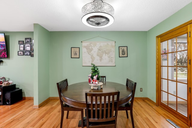 dining area with light hardwood / wood-style floors