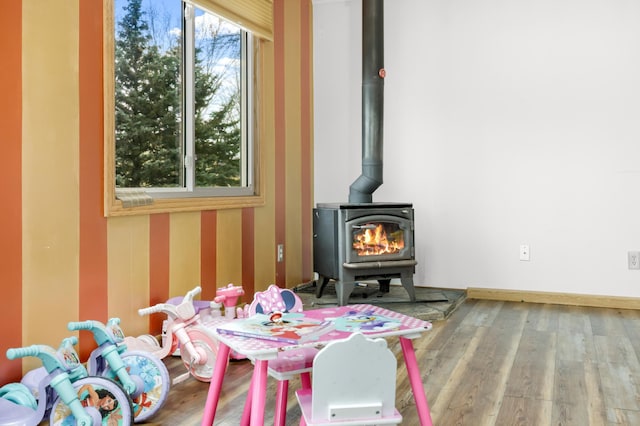 interior space featuring a wood stove and hardwood / wood-style floors