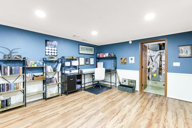 office featuring ornamental molding, heating unit, and light wood-type flooring