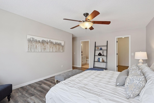 bedroom featuring hardwood / wood-style flooring, ensuite bathroom, ceiling fan, and a textured ceiling