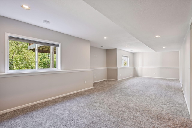 carpeted empty room with a wealth of natural light