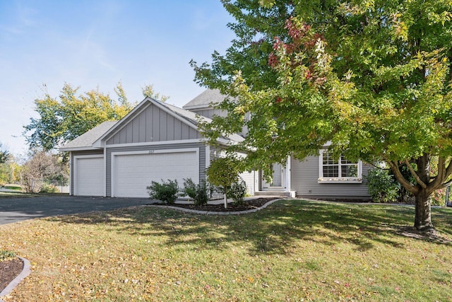 view of front of house with a garage and a front yard