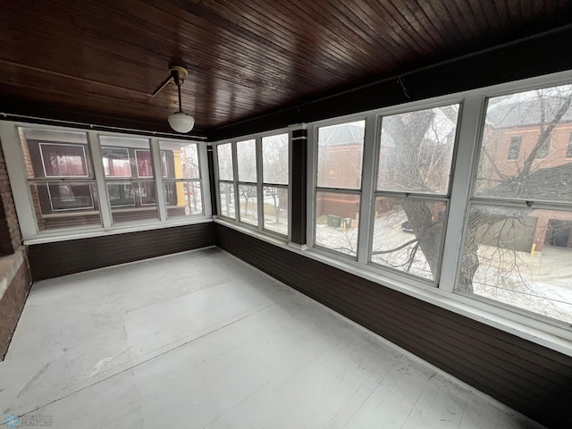 unfurnished sunroom with a wealth of natural light and wooden ceiling