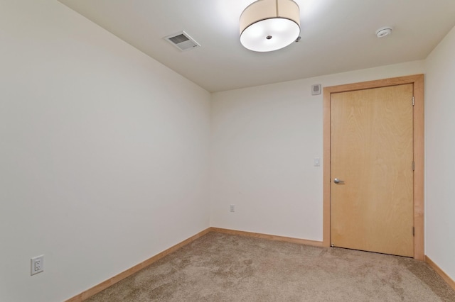 unfurnished room with light carpet