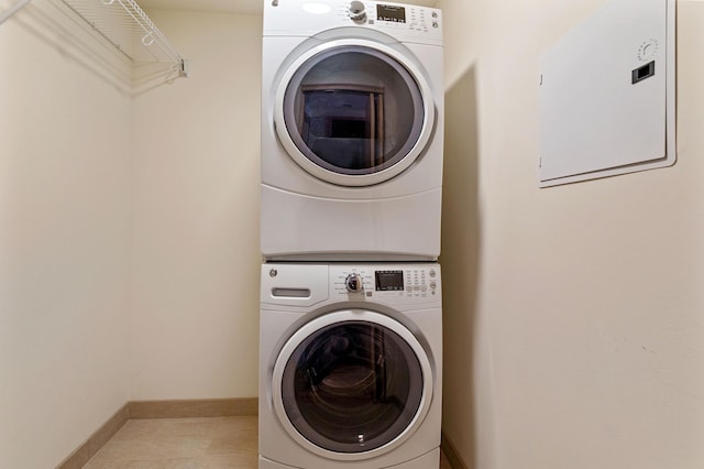 washroom featuring stacked washing maching and dryer