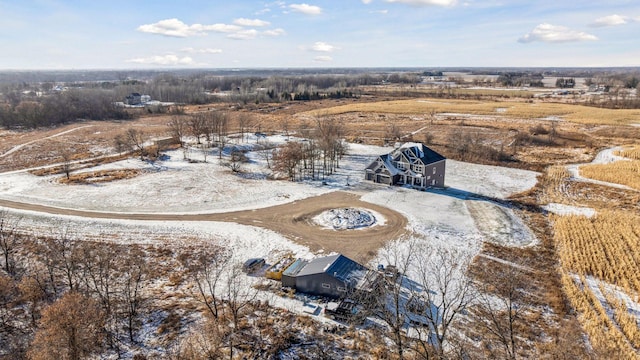 snowy aerial view featuring a rural view