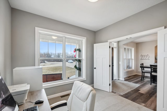 office featuring visible vents, baseboards, and wood finished floors