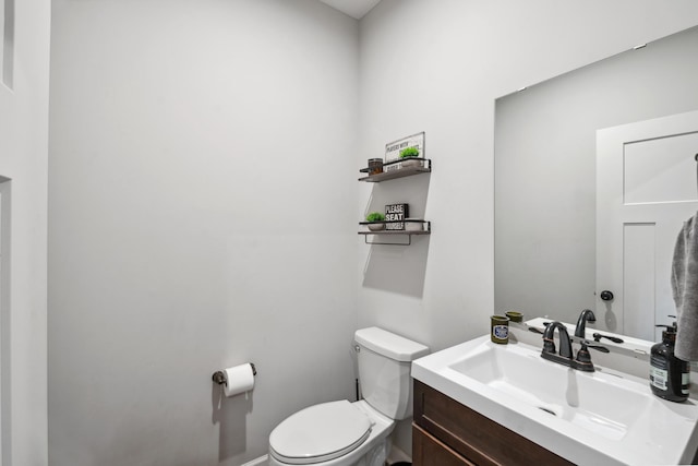 bathroom featuring toilet and vanity