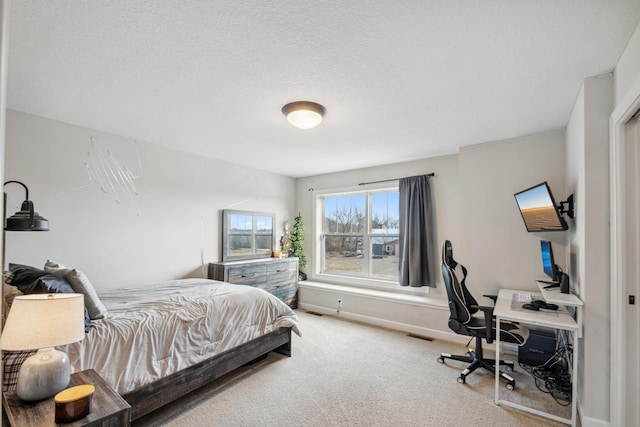 bedroom featuring visible vents, baseboards, a textured ceiling, and carpet flooring