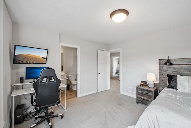 bedroom with baseboards, visible vents, a textured ceiling, carpet flooring, and connected bathroom