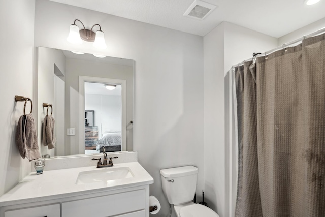 bathroom with visible vents, toilet, a shower with shower curtain, ensuite bathroom, and vanity