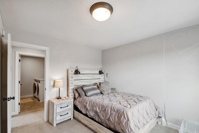 bedroom with visible vents, light carpet, independent washer and dryer, a textured ceiling, and baseboards