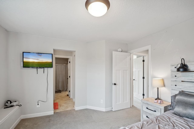 carpeted bedroom with baseboards and a textured ceiling