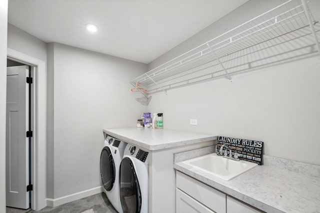 washroom featuring baseboards, laundry area, recessed lighting, a sink, and washer and dryer