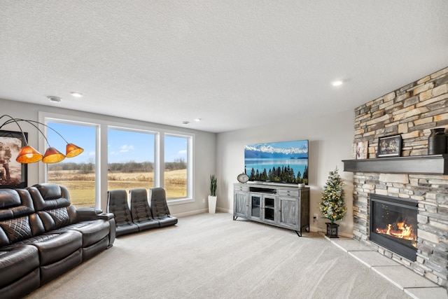 living room featuring a textured ceiling, recessed lighting, carpet flooring, a fireplace, and baseboards