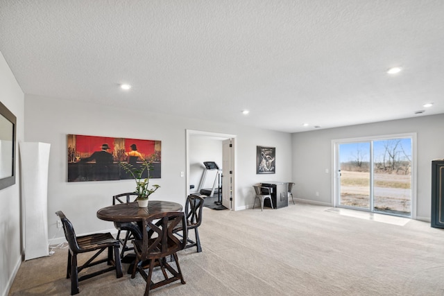 dining room with recessed lighting, light colored carpet, baseboards, and a textured ceiling