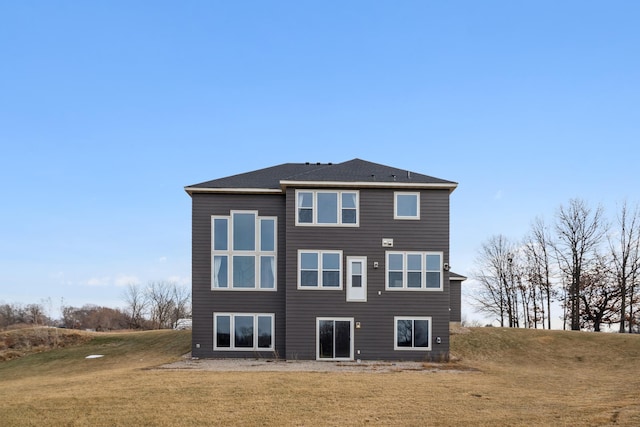 rear view of property featuring a yard