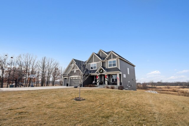 18340 Forest Rd N, Forest Lake, MN 55025 - craftsman-style home with covered porch, concrete driveway, a garage, and a front lawn