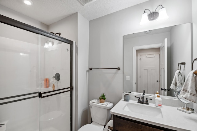 18340 Forest Rd N, Forest Lake, MN 55025 - bathroom with vanity, a stall shower, a textured ceiling, and recessed lighting