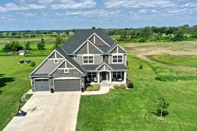 18340 Forest Rd N, Forest Lake, MN 55025 - craftsman-style home featuring covered porch, stone siding, concrete driveway, and a front yard