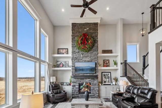 18340 Forest Rd N, Forest Lake, MN 55025 - living room with a stone fireplace, a high ceiling, ceiling fan, wood finished floors, and recessed lighting