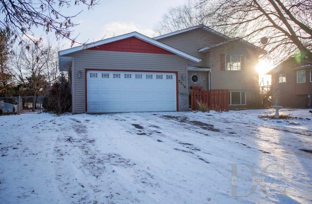 split level home with fence