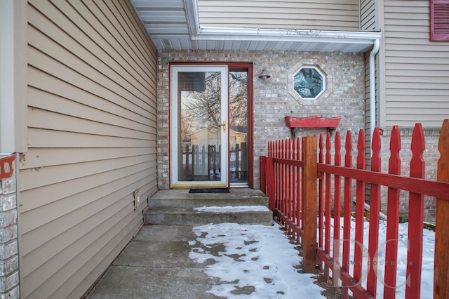 entrance to property featuring brick siding