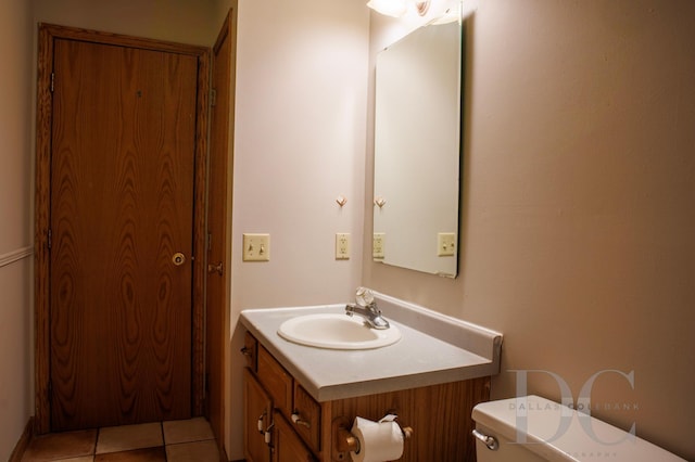 bathroom featuring toilet, tile patterned flooring, and vanity