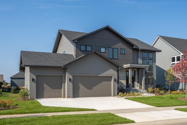 view of front of property with a garage and a front yard