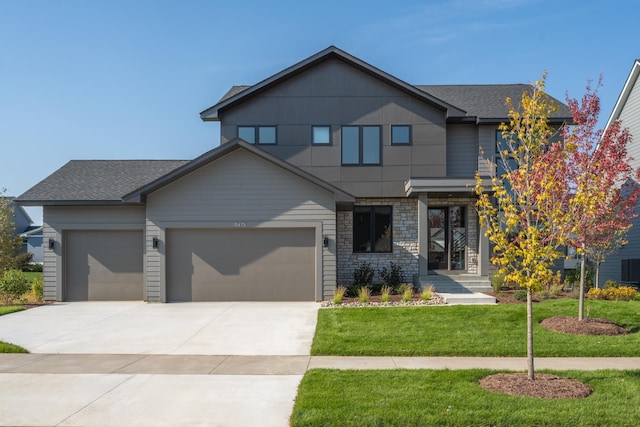 view of front of home featuring a front yard and a garage