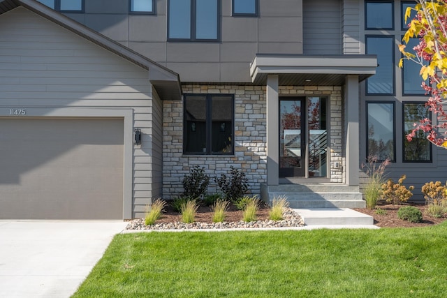 property entrance featuring a lawn and a garage