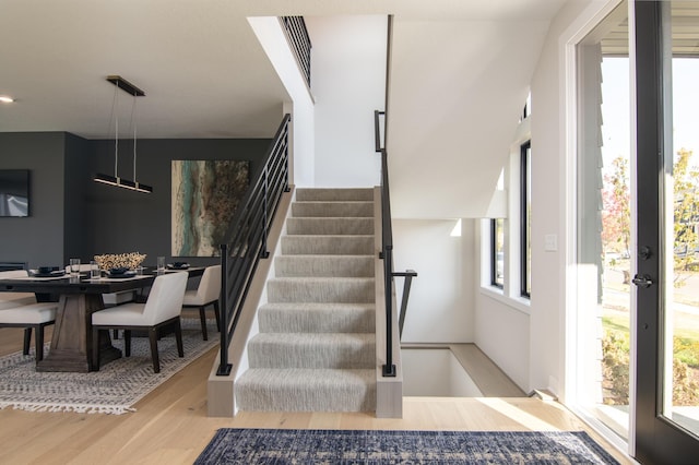 stairs with hardwood / wood-style floors