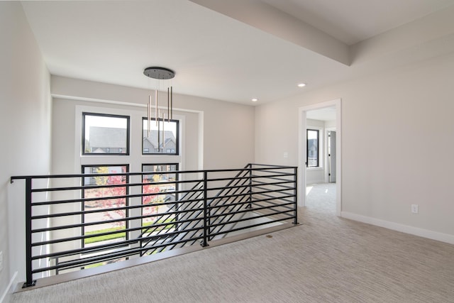 carpeted spare room with a healthy amount of sunlight