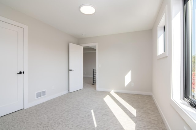 unfurnished bedroom featuring light carpet