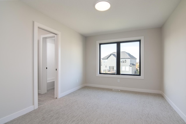 empty room featuring light colored carpet