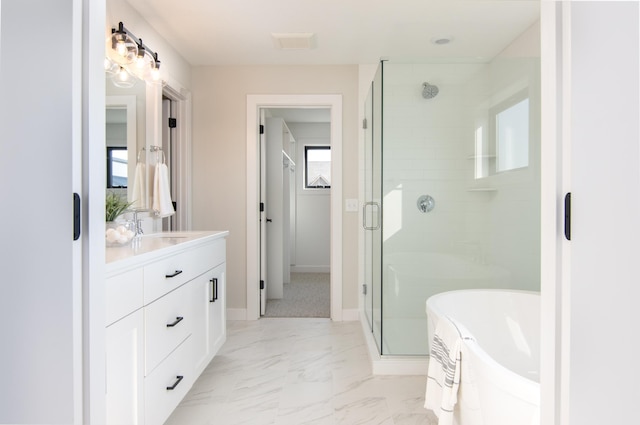 bathroom featuring vanity and independent shower and bath