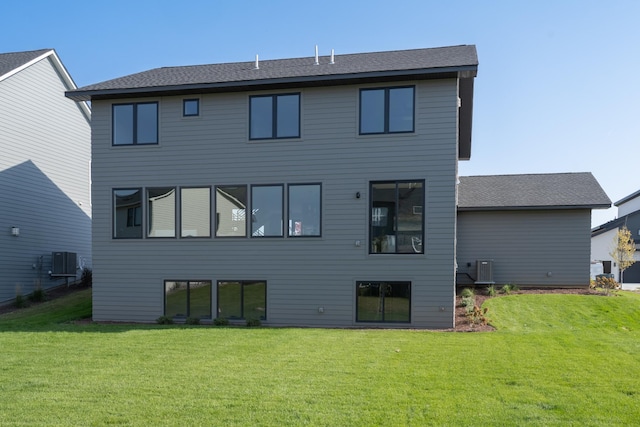 back of property featuring a lawn and central AC unit