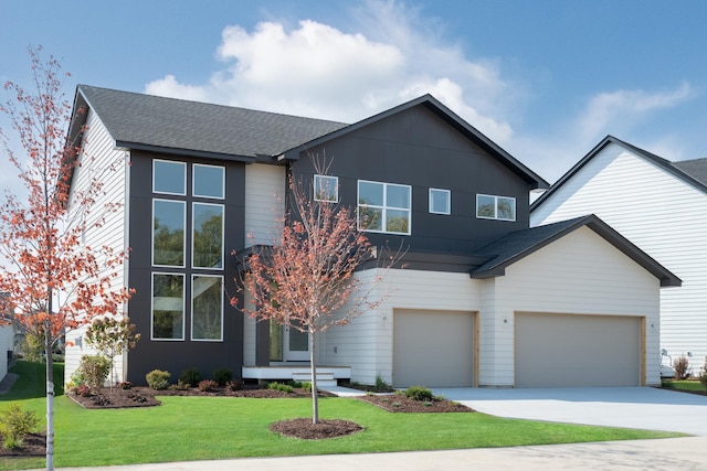 view of front of home featuring a front yard and a garage